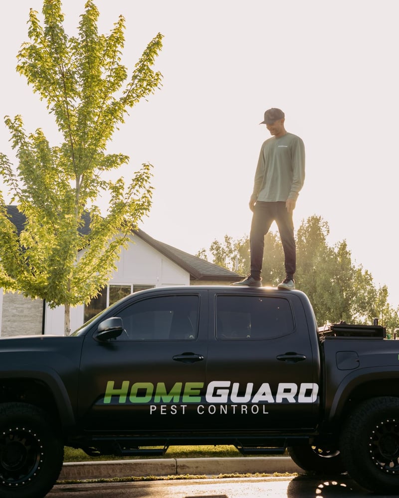 HomeGuard Pest Control truck parked in a Cache Valley neighborhood