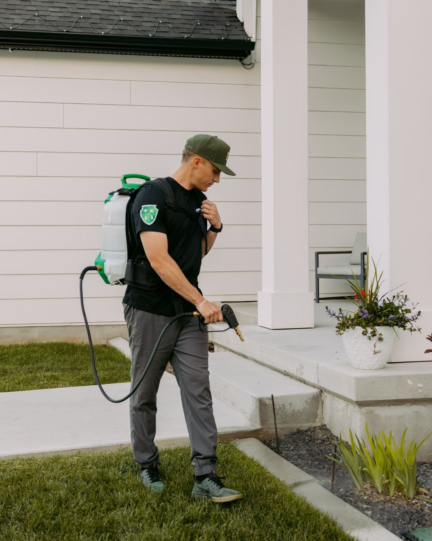 HomeGuard technician treating a front porch and entry area